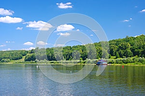 Old pier on a quiet river in summer