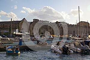 Old pier with stone houses and boats on the island of Crete, Greece