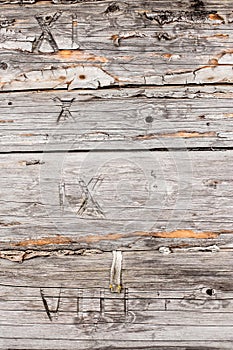 Old pine logs of wooden house with numerals