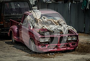 Old pink pickup truck abandoned in wasteland
