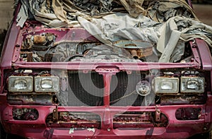 Old pink pickup truck abandoned in wasteland