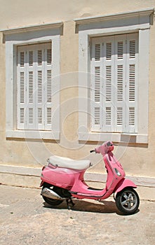 Old Pink Scooter with Window Shutters Background in Kalymnos, Greece