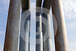 The old pipe on a background of blue sky with white clouds