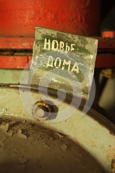 Old pipeline with sign written in cyrillic