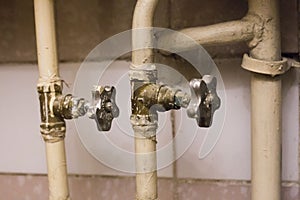 Old pipes with broken faucet valves.