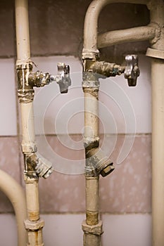 Old pipes with faucet valves and broken filters