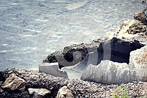 Old pipes with wastewater going into the sea