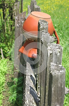 Old pitcher on fence