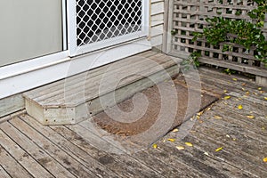 Old plain coir doormat placing in front of the doorstep