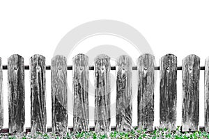 Old plank wood small fence wall with vertical patterns and green grass flloor in garden isolated on white background , clipping