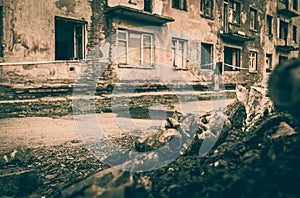 Old plastic broken doll in a pile of garbage