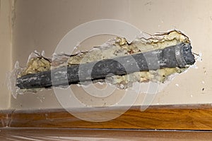 Old plastic pipe from the sewage system in the wall of a detached house
