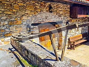 Old plow located at the entrance of a house in Spain as decoration. The plow was used in the field to plough the field pulled by