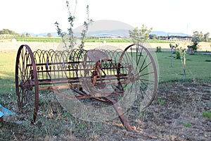 Old plow in tuscan country in a sunny afternoon