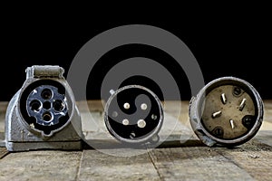 Old plug and socket high voltage. Old electrical accessories. Wooden table.