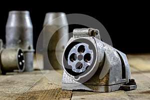 Old plug and socket high voltage. Old electrical accessories. Wooden table.