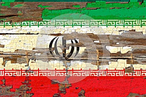 Old plumbed Iran flag on wood.