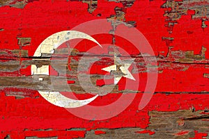 Old plumbed Turkey flag on wood.