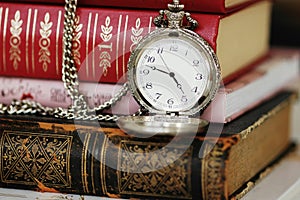 Old pocket-watch and books