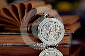 Old pocket watch and books