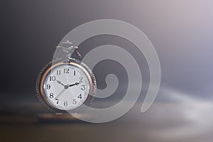 Old pocket watch on dark background