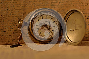 Old pocket watch with key
