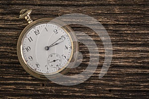 Old Pocketwatch Over Rough Wood Background