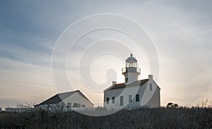 OLD POINT LOMA LIGHTHOUSE BACKLIT BY SUNSET AT POINT LOMA SAN DIEGO CALIFORNIA USA