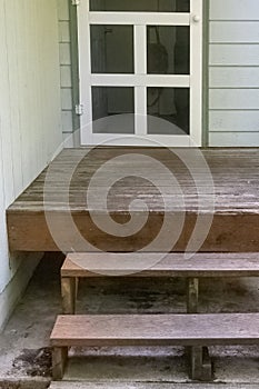 old porch steps on a concrete slab