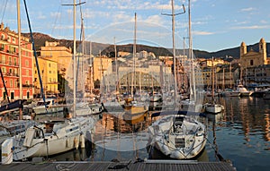 The old port of Bastia Corsica France with St. John the Baptist historic church and shops restaurants cafes and yachts boats