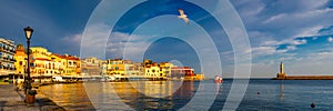 Old port of Chania with flying seagulls. Landmarks of Crete island. Bay of Chania at sunny summer day, Crete Greece. View of the