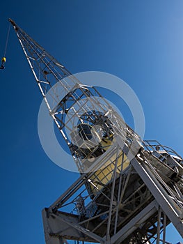 Old port  crane over blue sky