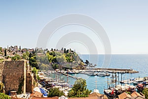 The old port of Kaleichi in Antalya and the fortress. yachts in the harbor of the bay , blue sea and sky. tourist historical place photo