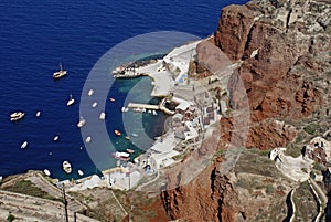 Old port of Oia village at Santorini island in aegean sea, Greece. Santorini is a volcanic island at the Cyclades