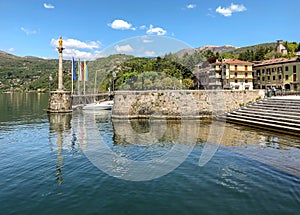 The old port with the statue of Madonnina in Luino, Italy