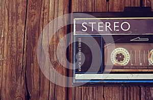 Old portable cassette player on a wooden background. image is instagram style filtered