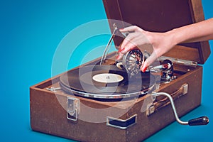 Old portable gramophone with female hand