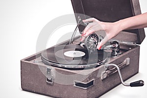 Old portable gramophone with female hand