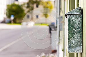 An old post box on a wooden wall in Norway, outdoors