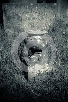 Old pot on a overgrown grave