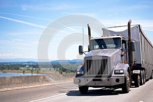 Old power big rig semi truck with trailer for bulk cargo moving