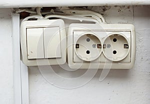 Old power socket and switch on the wall