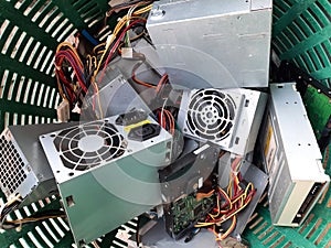 Old Power supply and hard disk dive computer hardware accessories in the basket, Obsolete equipment is electronic waste Reuse and