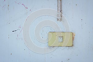 Old power switch on a dirty wall.