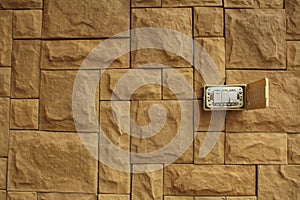 Old Power switch on the walls of the orange stone stacked beautifully, White switch on the red brick wall