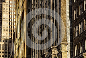 Old pre-modern 1900`s architectural city office building facades , brick, stone, modern office building in background