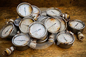 Old pressure gauge or damage pressure gauge of oil and gas industry on wooden background, Equipment of production process
