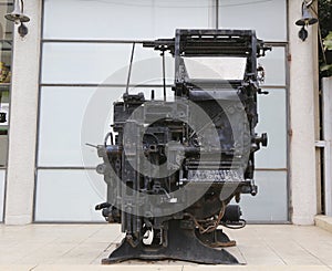 An old printing press machine being exhibited in the entrance of the Journalistic Center in Tel Aviv