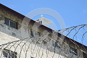 Old prison building with fence