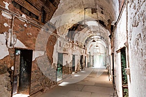 Old prison corridor with open cells.